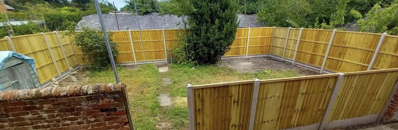 Garden fully enclosed with new fencing panels both sides